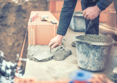 Detail of mason worker working with construction spatula