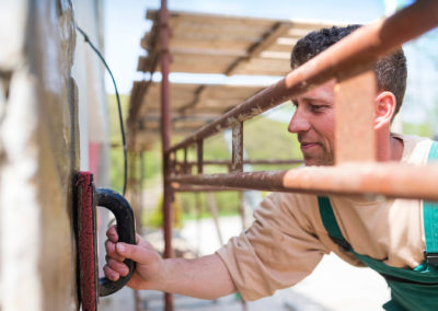 Man putting natural stones on wall