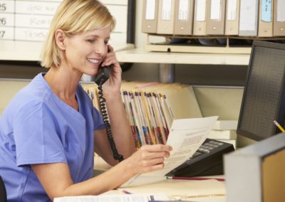 Nurse making phone call at nurses station