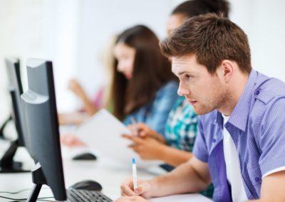 Student with computer studying at school