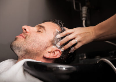 Man getting his hair washed and his head massaged in a hair salon