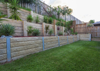 Multi-level retaining wall with plants in backyard