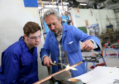 Teacher with student in metallurgy workshop
