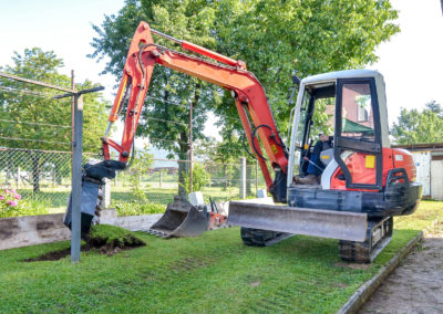 Digger excavating the lawn.